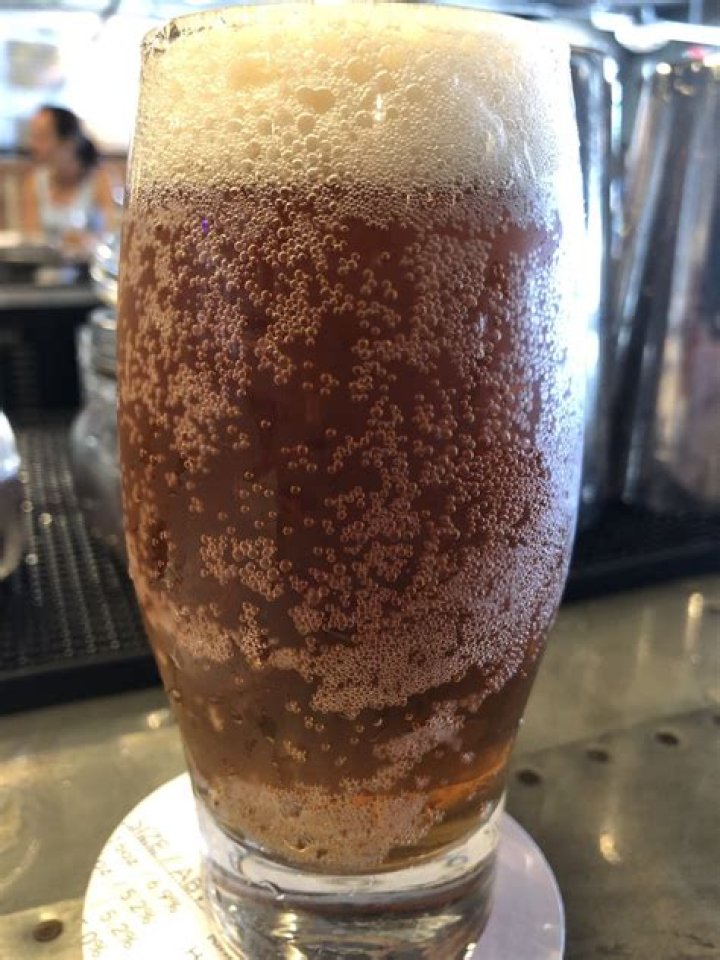 What is the foam on the side of a beer glass called?