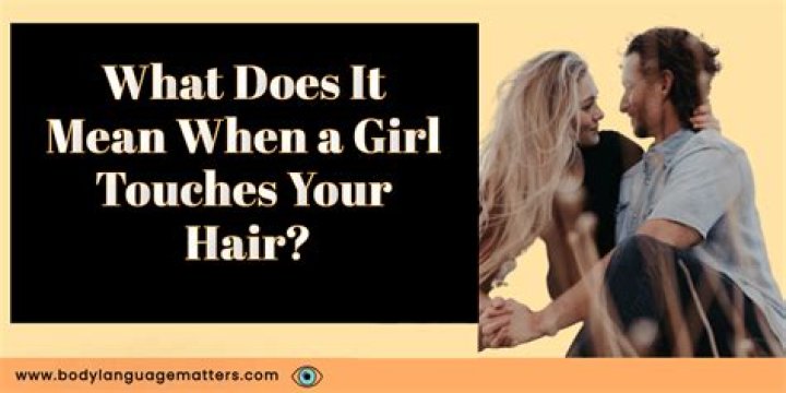 What it means when a girl touches her hair?